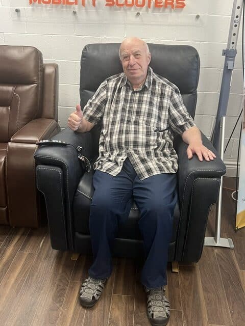 Happy customer with lift chair at Vital Mobility Vaughan showroom